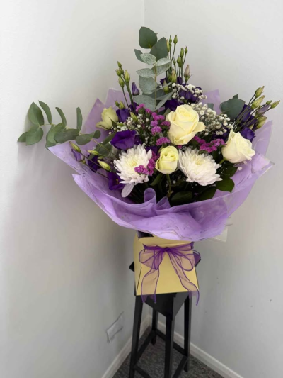 Lavender Meadow Hand-Tied - A soft and elegant hand-tied bouquet blending gentle pastel tones with fresh greenery for a naturally relaxed and graceful look. Beautifully wrapped in delicate lilac packaging and finished with a coordinating ribbon, this arrangement offers a light and airy feel.

Perfect for thoughtful gifting, birthdays, or simply adding a touch of calm beauty to the home, this bouquet is designed to bring charm, serenity, and effortless elegance to any occasion.